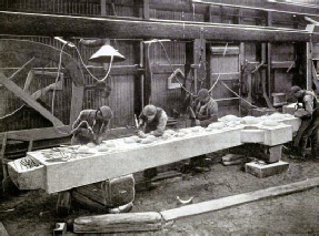 PNEUMATIC CARVING TOOLS BEING APPLIED TO A CELTIC CROSS OF GREY GRANITE